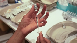 Medical staff prepares a syringe with a COVID-19 vaccine.