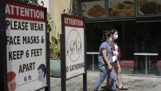 People wearing face masks at an outdoor mall in Los Angeles.