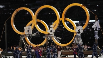 Dancers perform during the opening ceremony in the Olympic Stadium