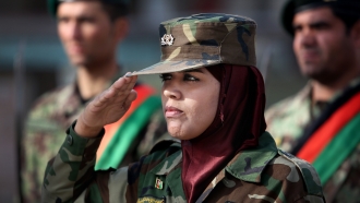 A woman from the Afghan National Army salutes her commander.