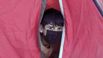 A displaced Afghan boy from northern provinces, who fled his home due to fighting between the Taliban and Afghanistan