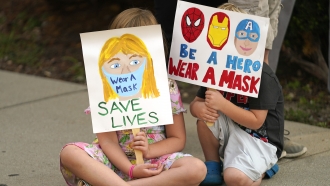 Parents and students during a rally at Utah State School Board Office calling for mask mandate in Salt Lake City