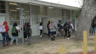 Children walk into school.
