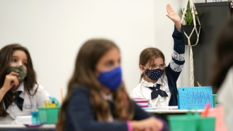 Children in a Florida school wearing face masks to guard against COVID-19 infections.