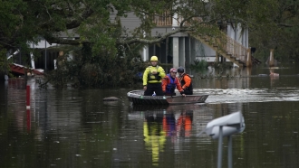 Rescue crew boats down a flooded street after Hurricane Ida in Lafitte, Louisiana.