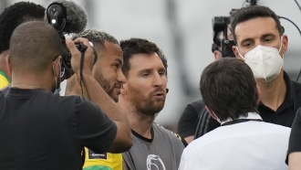 Argentina's Lionel Messi, center, Brazil's Neymar, left, and Argentina's coach Lionel Scaloni talk.