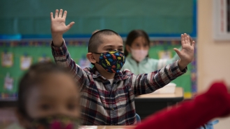 Kindergarten students in masks in a classroom