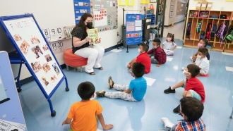 A pre-K teacher teaches 3- and 4-year-old students in her classroom