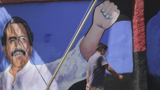 A man walks past a mural of Nicaraguan President Daniel Ortega