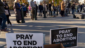 People listen during an anti-abortion rally outside of the Supreme Court
