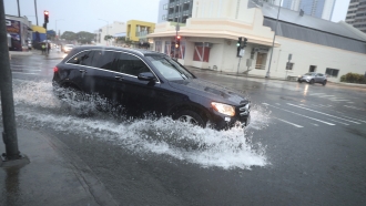 Car drives on flooded street in Hawaii