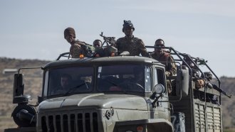 Ethiopian government soldiers ride in the back of a truck on a road near Agula.