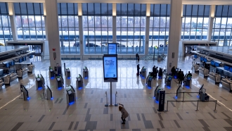 Passengers move about a spacious Terminal B of New York's LaGuardia Airport