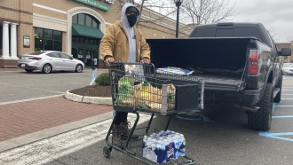 A man picks up extra provisions at a grocery store ahead of a storm.