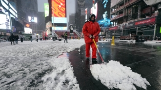 Worker clears snow in New York's Times Square