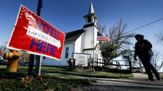 A voting sign is shown outside a church.