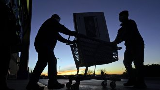 People move consumer goods in a cart
