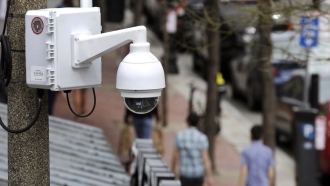 Surveillance camera attached to a street light pole
