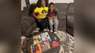 Dr. Tamecca Rogers and Son Keith pose with the children's books they've written together
