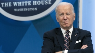 President Joe Biden sits during an event.