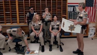 A still from a "Reno 911!" scene is shown.