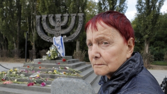 A woman stands near a memorial to victims of the 1941 Nazi massacre of Jews in Babi Yar in Kiev, Ukraine.