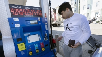 A man prepares to pump gas into his car