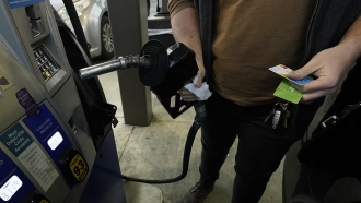 A customer prepares to pump gasoline