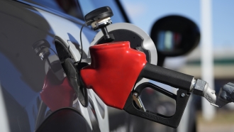 A motorist fuels a vehicle at an Exxon station.