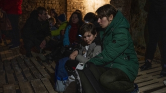 People shelter underground following explosions in Lviv, Ukraine.