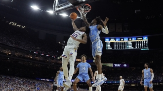 Kansas guard Ochai Agbaji shoots over North Carolina guard Leaky Black during the first half of a college basketball game