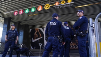 Police officers patrol a subway station in New York.