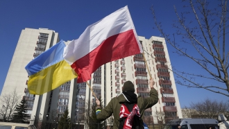 A man waves the Ukrainian and Polish flag during a demonstration