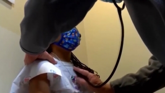 Doctor uses a stethoscope on a child patient