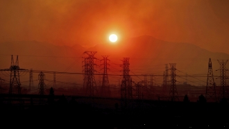 Wildfire smoke hangs above power lines