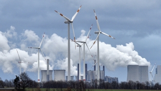Wind turbines in front of a coal fired power plant
