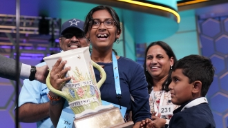 Harini Logan, 14, from San Antonio, Texas, celebrates winning the Scripps National Spelling Bee with her family