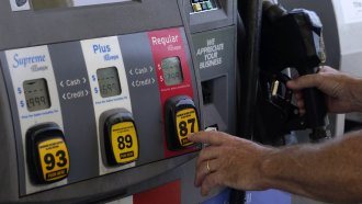 A customer pumps gas at an Exxon gas station.