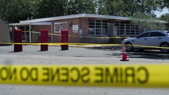 Crime scene tape surrounds Robb Elementary School after a mass shooting in Uvalde, Texas.