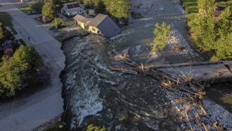 A house is washed away by floodwaters.