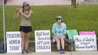 Abortion rights supporter Elli Morris, left, played her bamboo flute outside the Jackson Women's Health Organization