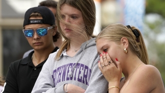 People mourn following a mass shooting