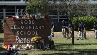 Investigators search for evidences outside Robb Elementary School in Uvalde, Texas.
