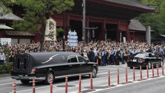 The vehicle carrying the body of former Japanese Prime Minister Abe Shinzo leaves Zojoji temple