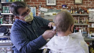 A man receives a haircut