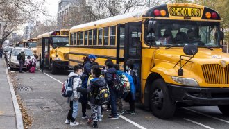A school bus picks up kids.