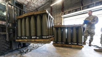 U.S. military member checks pallets of shells bound for Ukraine