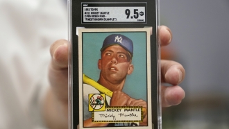 A Mickey Mantle baseball card is displayed at Heritage Auctions