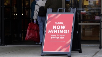 Hiring sign is displayed outside of a retail store in Vernon Hills