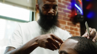 Clean Is Mandatory Owner Andre Scott gives a customer a haircut